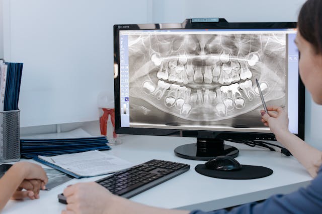 Transparent aligner tray held up to light