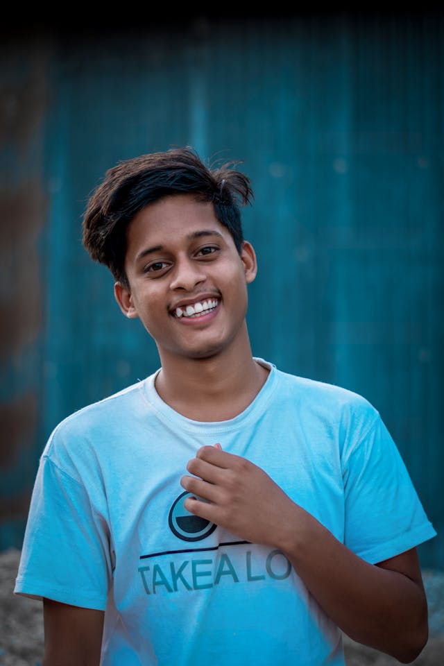 College student smiling confidently after Invisalign treatment